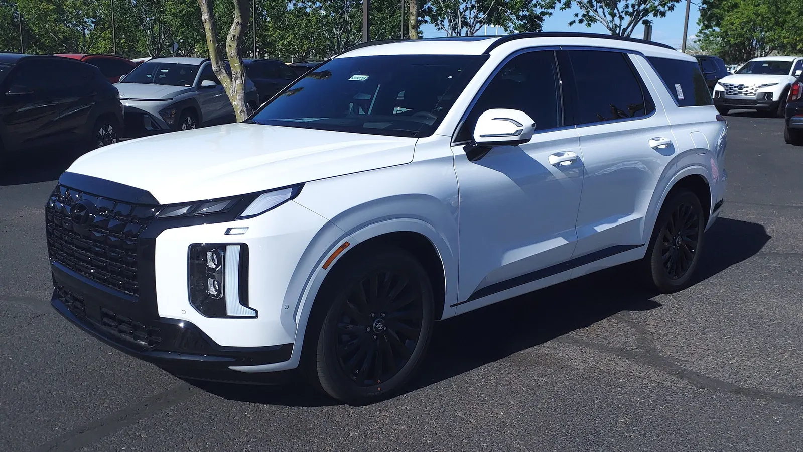 White 2024 Hyundai Palisade with black trim, front three-quarter view